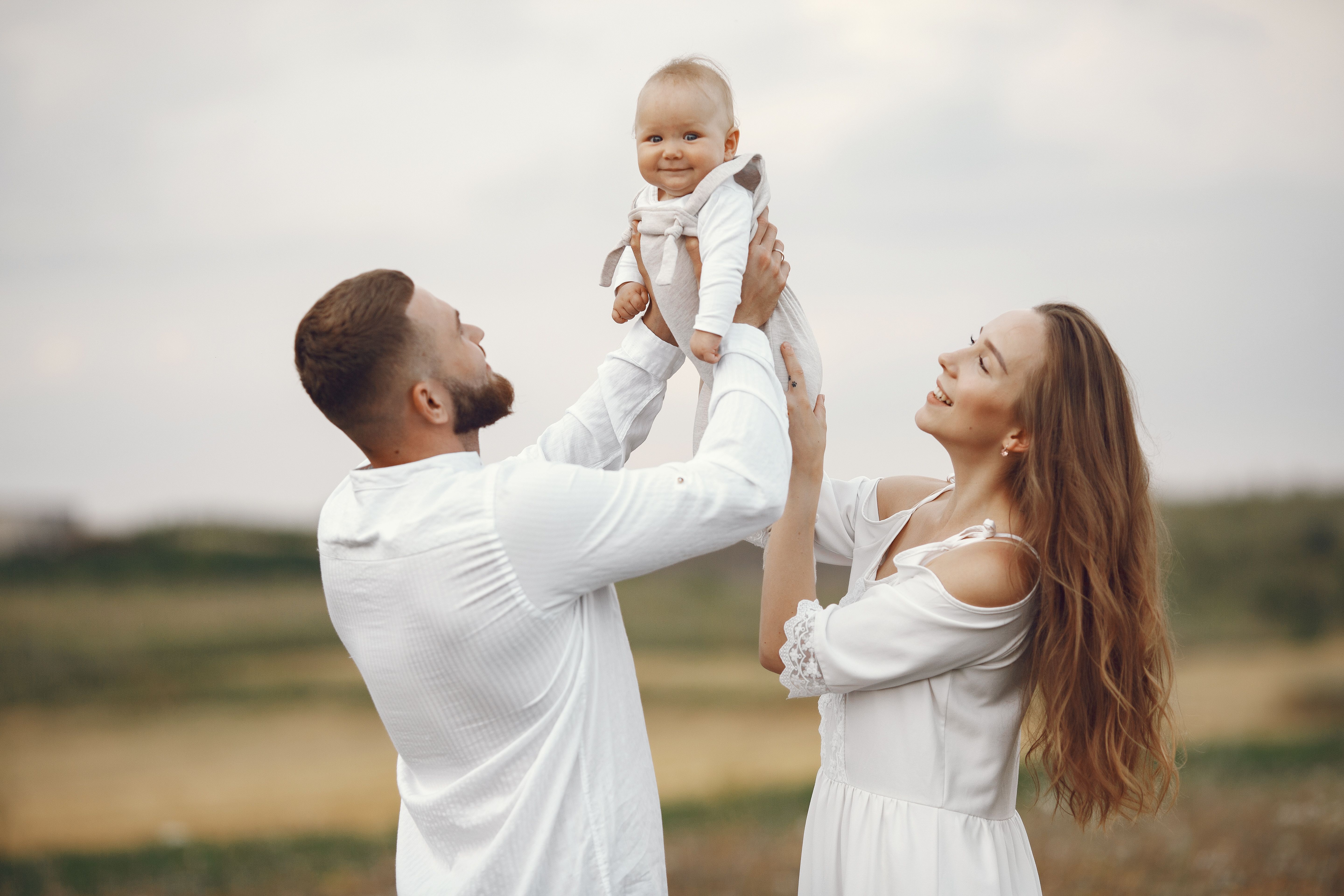 Family together outdoors while reviewing life and health insurance protection options